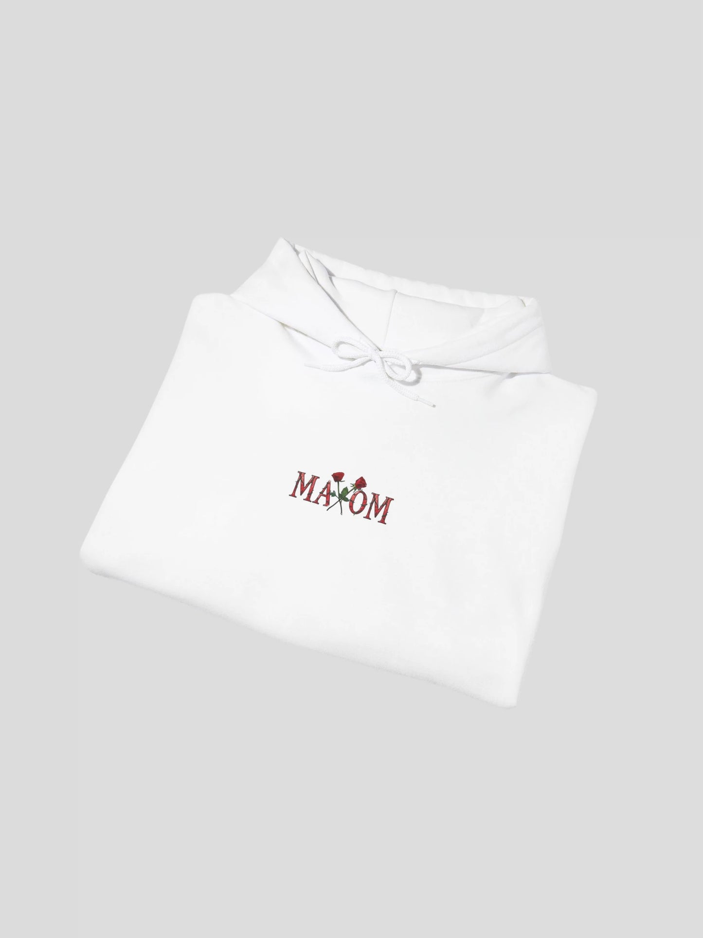 Folded flatlay of the White Rose Graphic Streetwear Hoodie highlighting the embroidered rose logo – a premium cotton streetwear hoodie for everyday comfort.