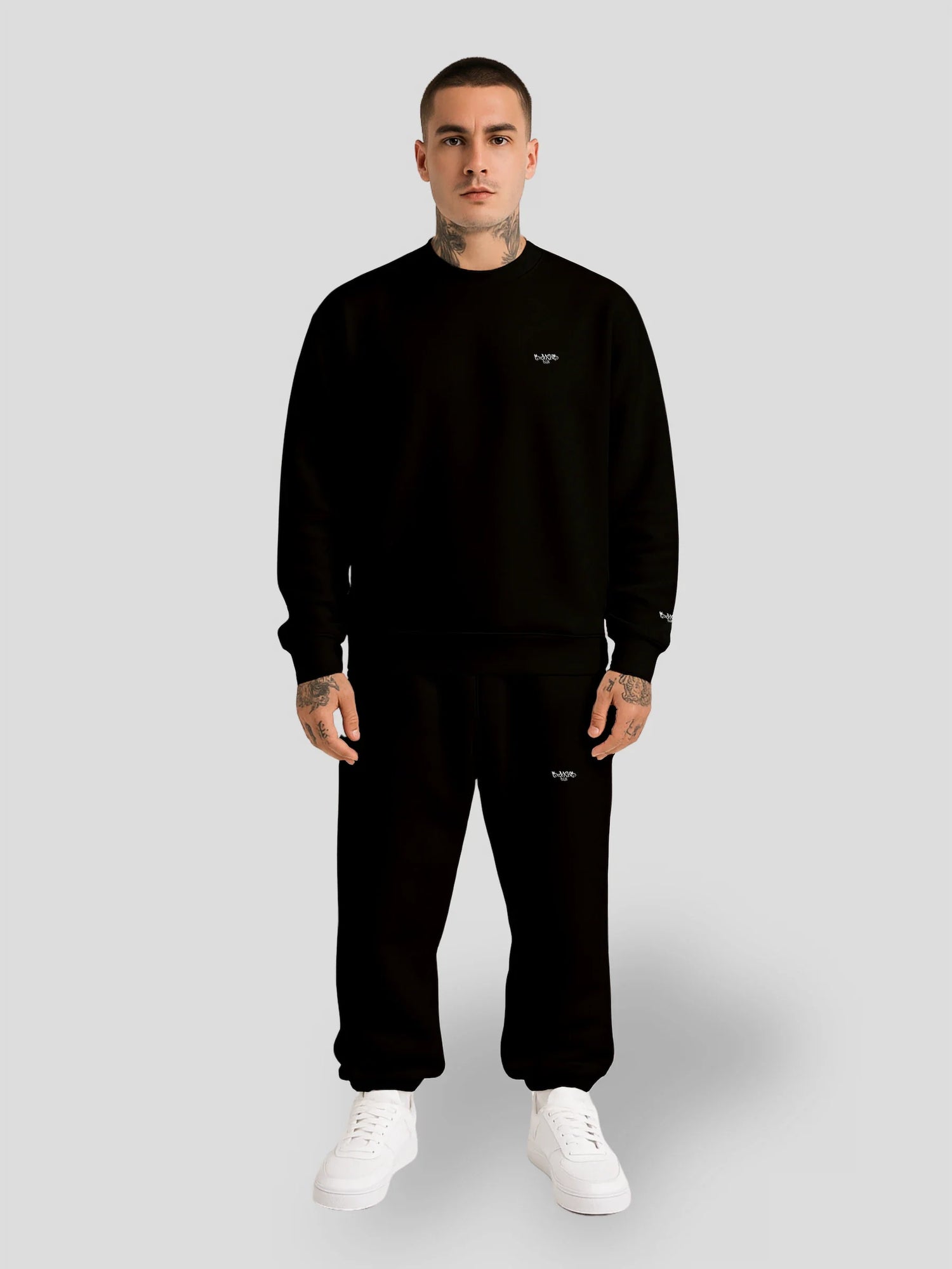 Male model wearing black oversized sweater and baggy sweatpants — MAXOMclo ECHO Collection streetwear bundle
