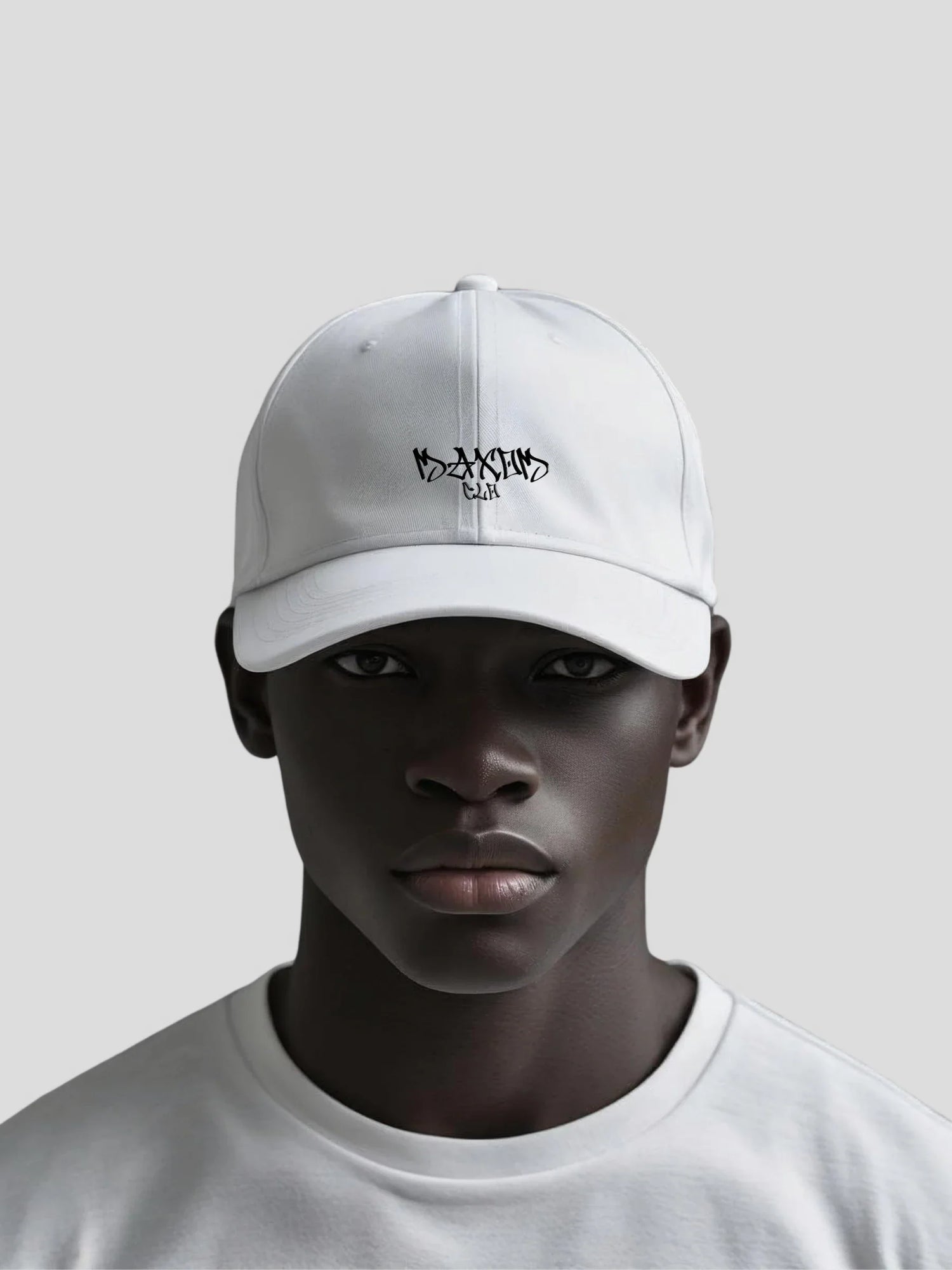 Dark-skinned model wearing a white modern streetwear baseball cap with black MAXOMclo graffiti logo — Hats Collection