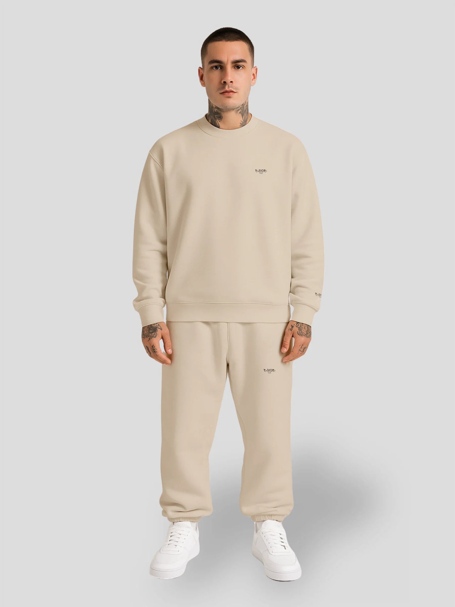 Male model wearing beige oversized streetwear bundle with sweatshirt and baggy sweatpants — MAXOMclo Bundles Collection