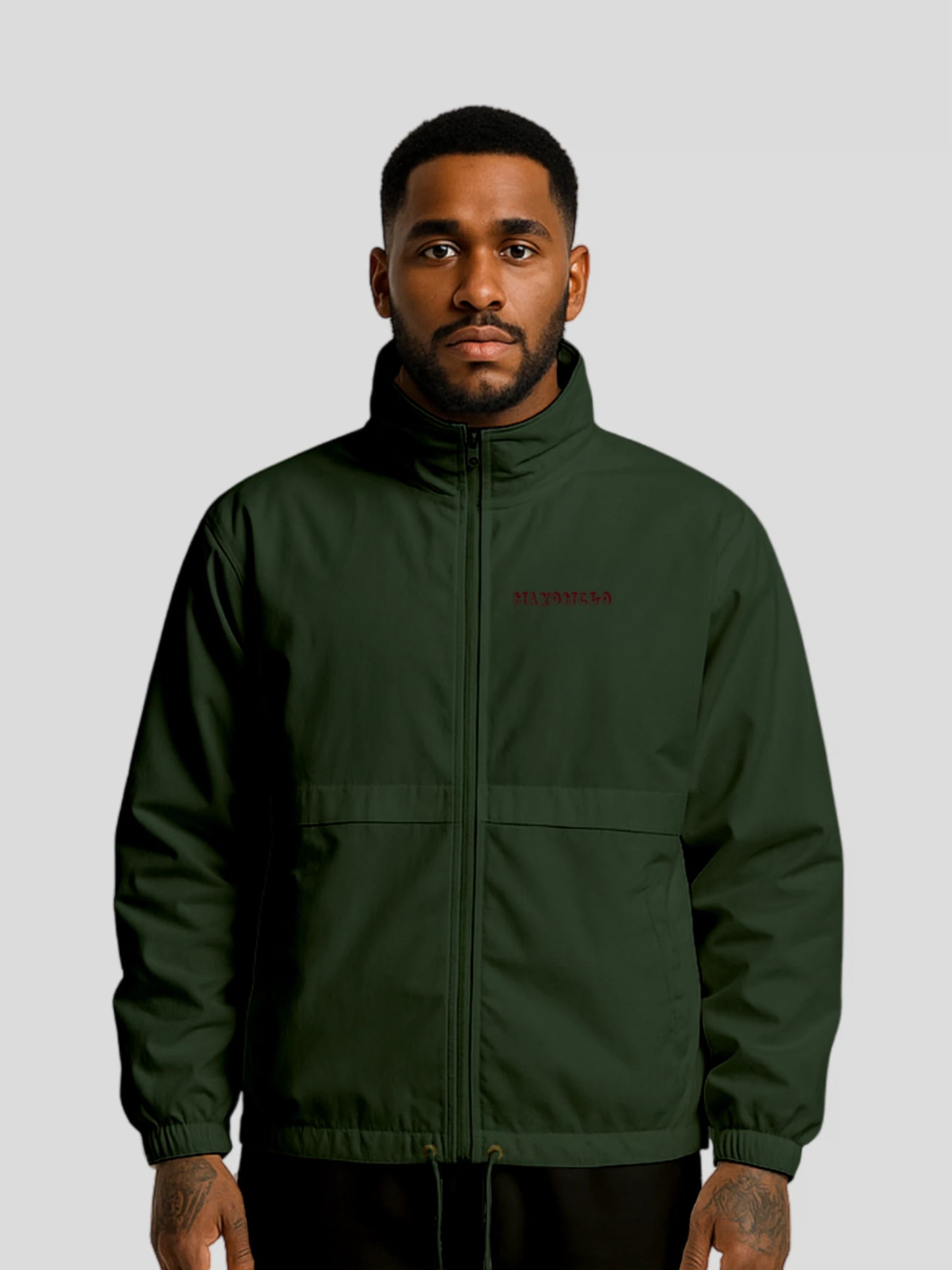 Model wearing the forest green streetwear windbreaker jacket – vegan streetwear windbreaker with elastic cuffs and adjustable hem.