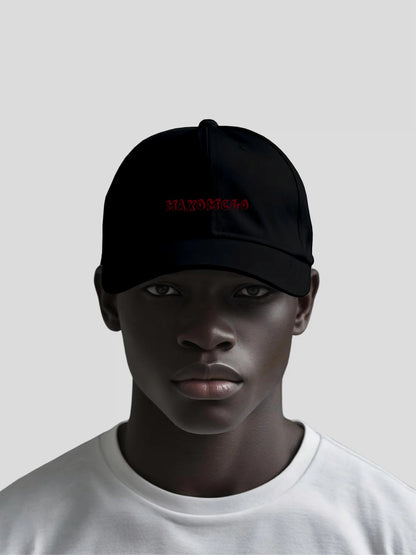 Model wearing the Crimson Stealth Unisex Baseball Cap by MAXOMclo – luxury unisex streetwear baseball cap with embroidered red MAXOMclo logo in black minimalist design.