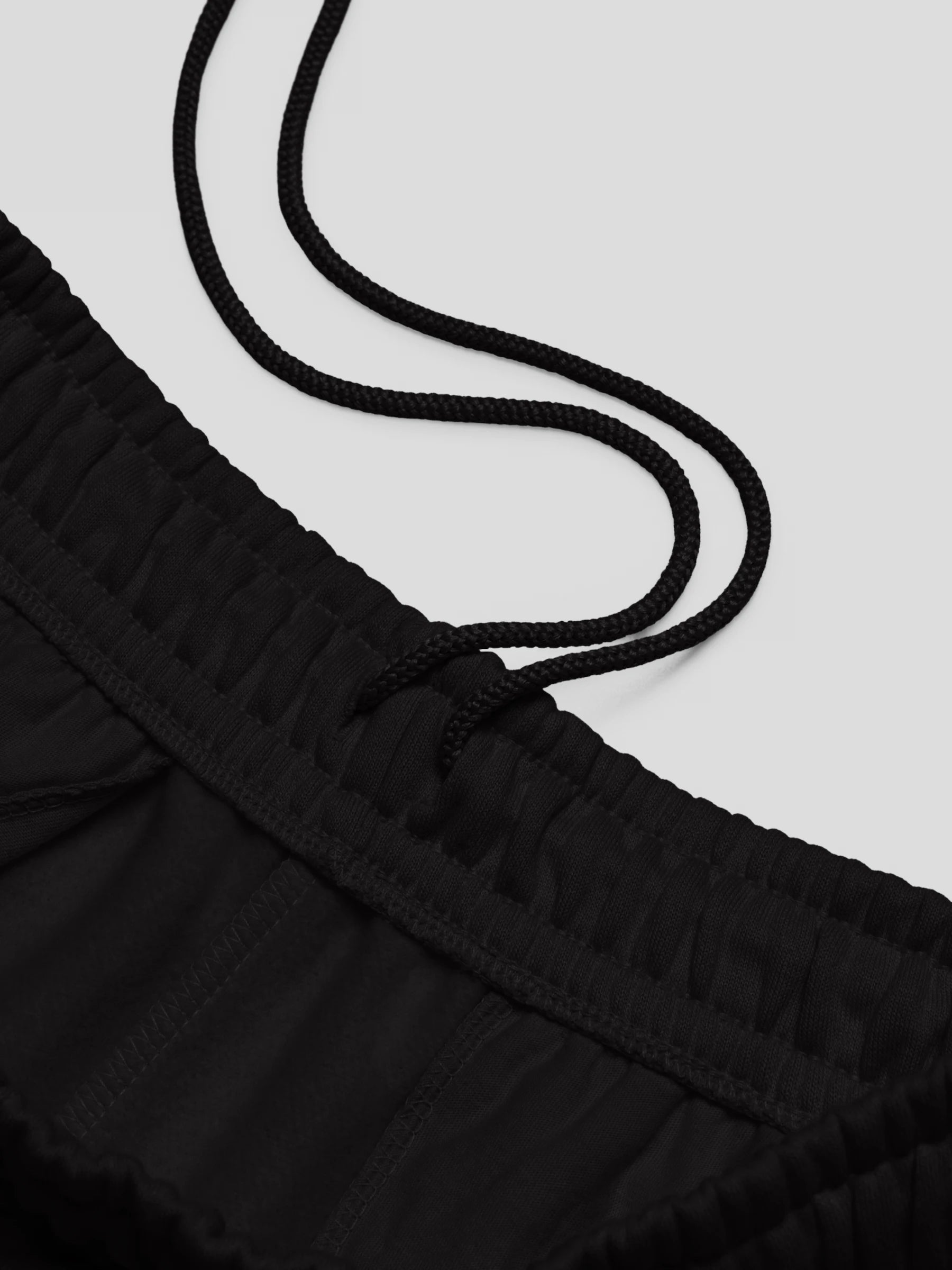 Close-up waistband of ECHO black joggers with interior drawcord