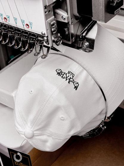 Embroidery detail of the ECHO White Streetwear Baseball Cap during production process.