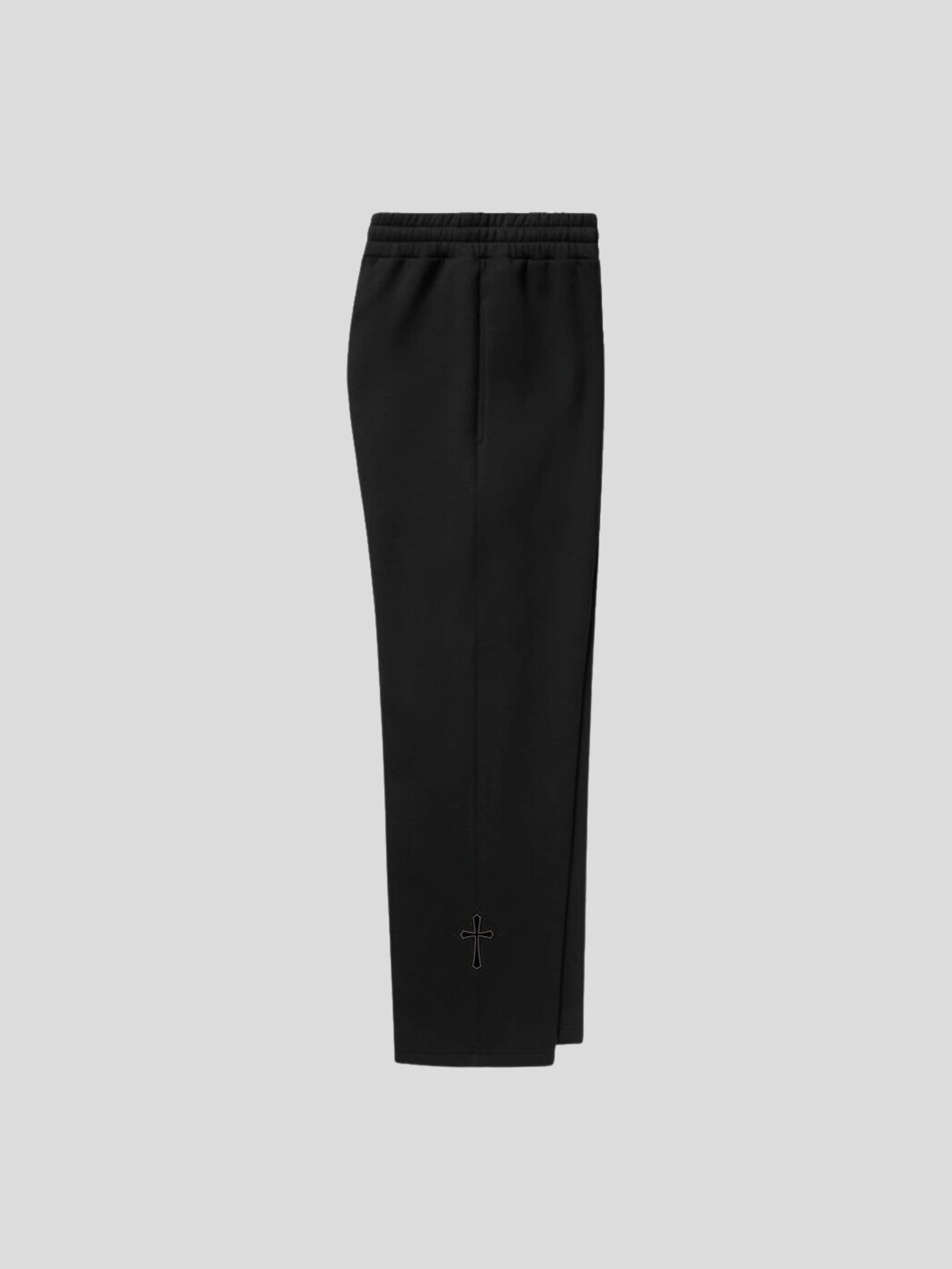 Right side of the MAXOMclo black oversized sweatpants – unisex streetwear joggers with gothic cross embroidery.