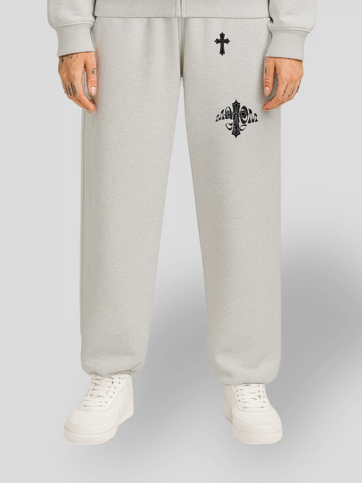 Model wearing the ELYSIUM Oversized Baggy Sweatpants in Grey by MAXOMclo – 380 GSM heavyweight unisex streetwear joggers with embroidered cross and gothic logo.
