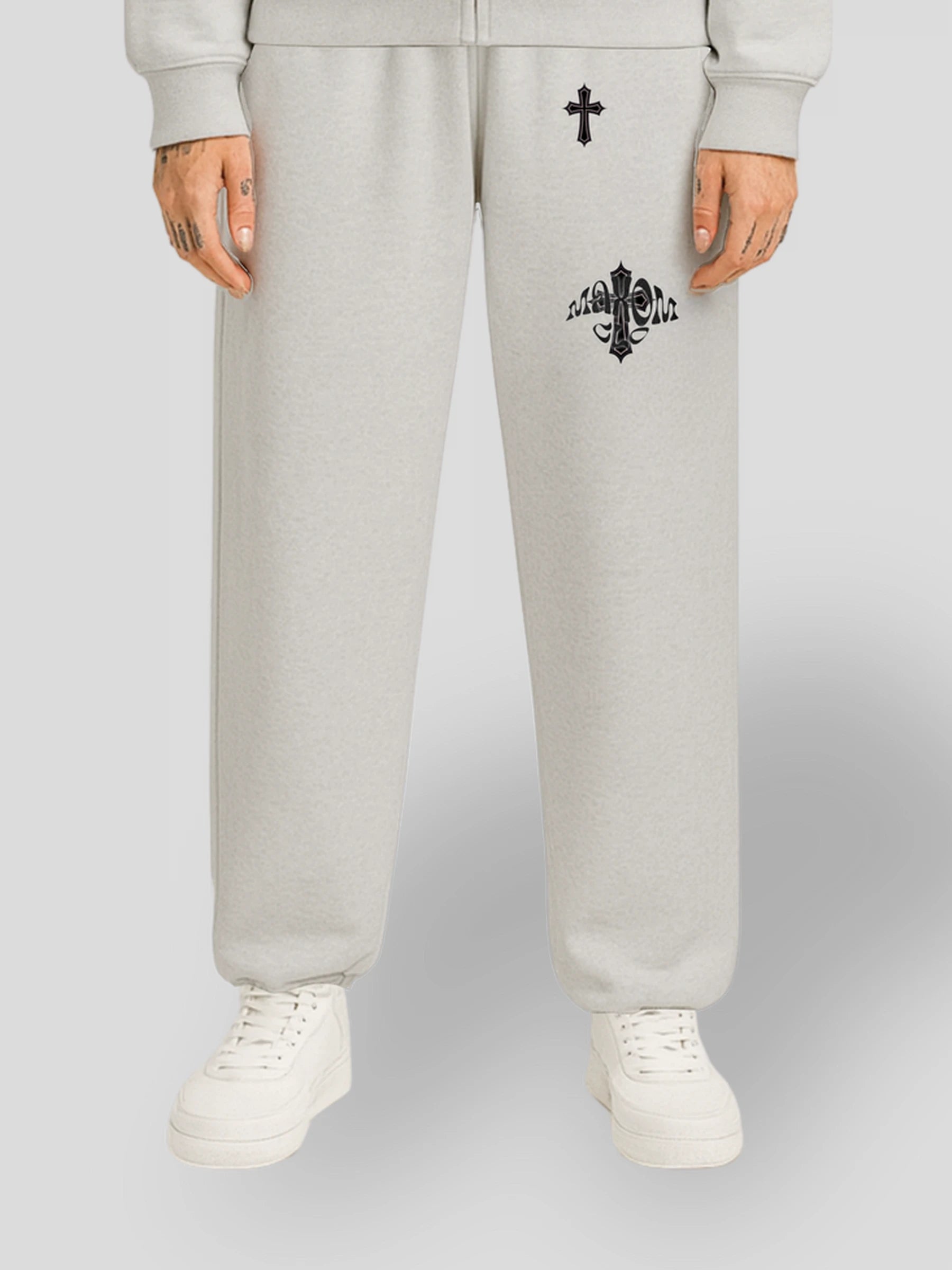 Model wearing the ELYSIUM Oversized Baggy Sweatpants in Grey by MAXOMclo – 380 GSM heavyweight unisex streetwear joggers with embroidered cross and gothic logo.