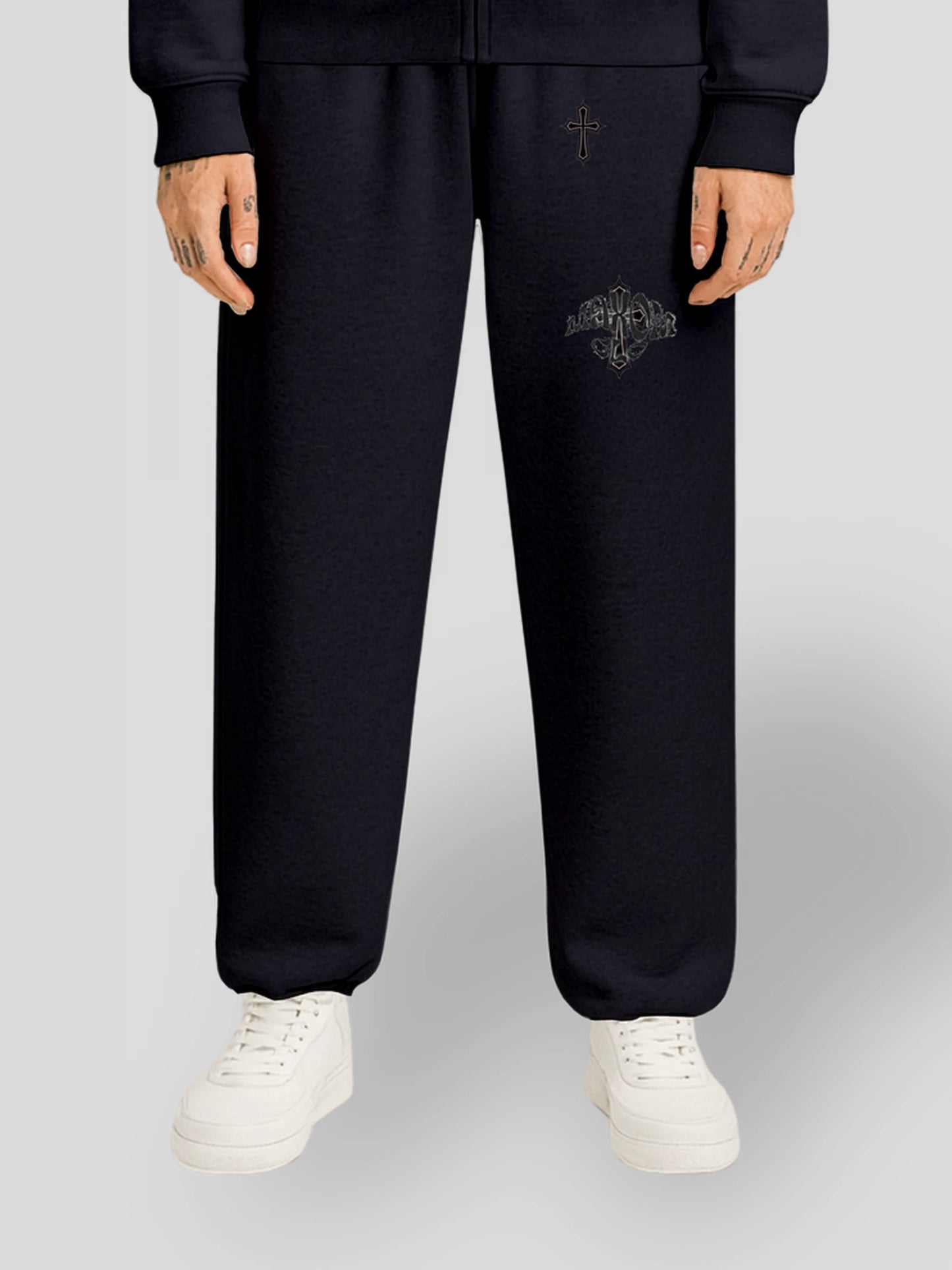 Model wearing the ELYSIUM Oversized Baggy Sweatpants in Navy Blue by MAXOMclo – luxury 380 GSM heavyweight unisex joggers with embroidered gothic cross detail.