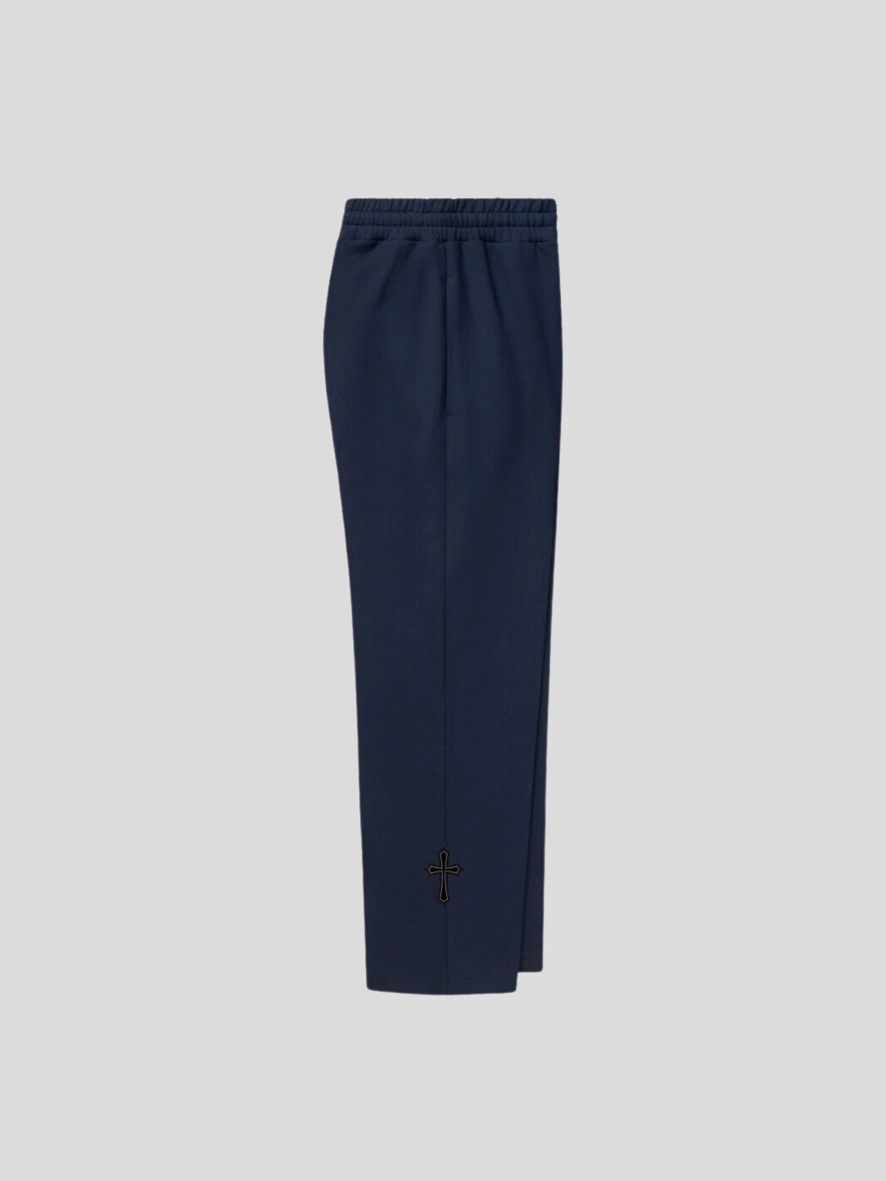 Right side of the MAXOMclo ELYSIUM navy baggy sweatpants, featuring embroidered cross logo and oversized silhouette.