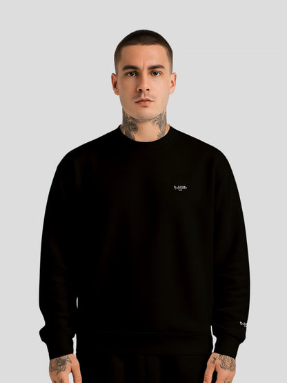 Male model wearing MAXOMclo ECHO BLACK oversized unisex luxury streetwear sweater with minimalist graffiti logo