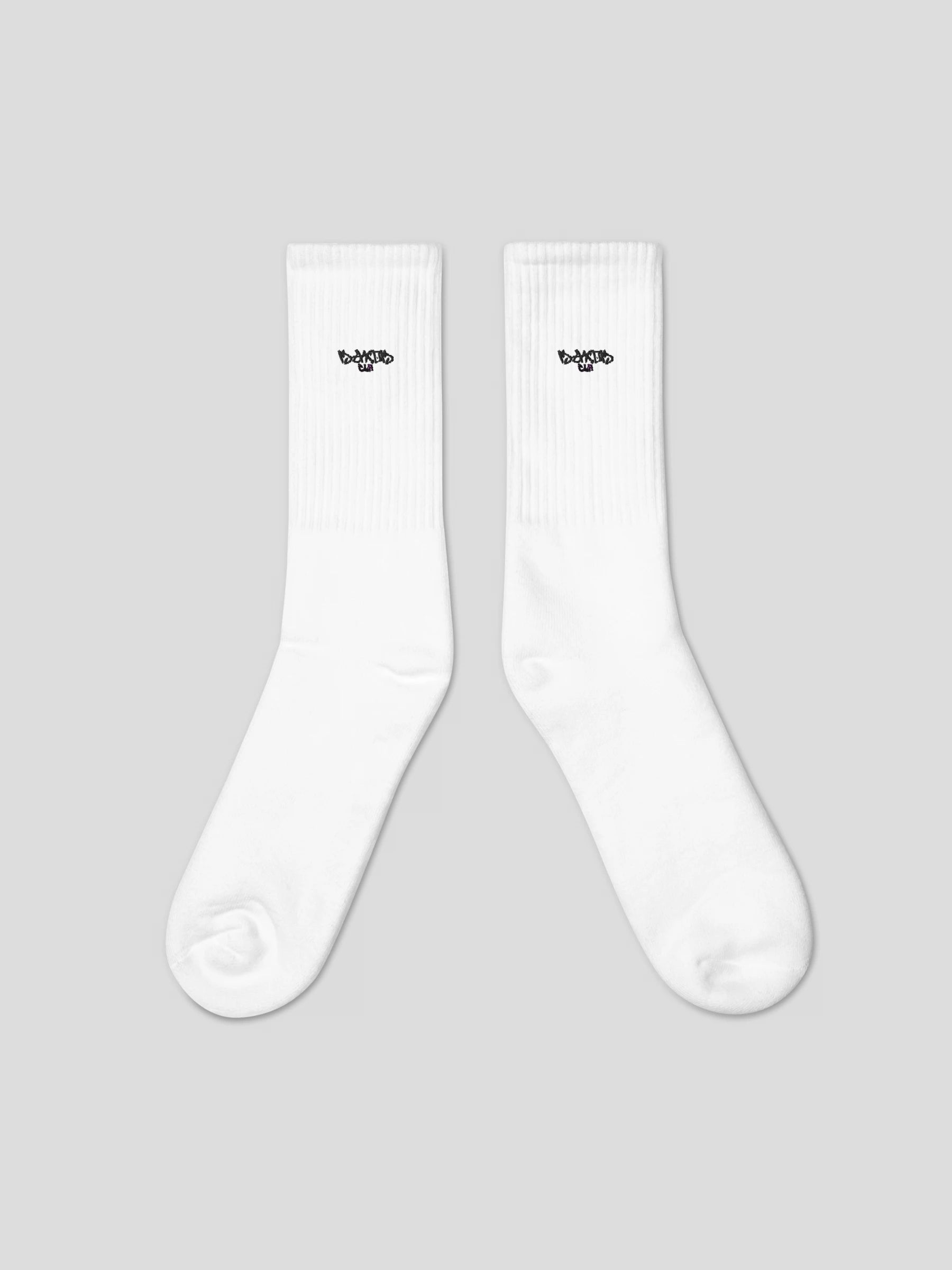 Flat lay of MAXOMclo ECHO Socks – minimal embroidered logo white socks for everyday streetwear style