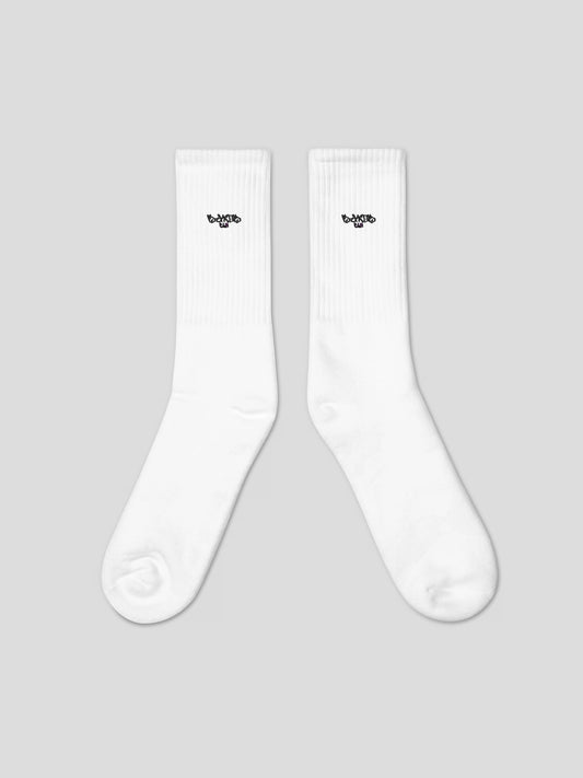 Flat lay of MAXOMclo ECHO Socks – minimal embroidered logo white socks for everyday streetwear style