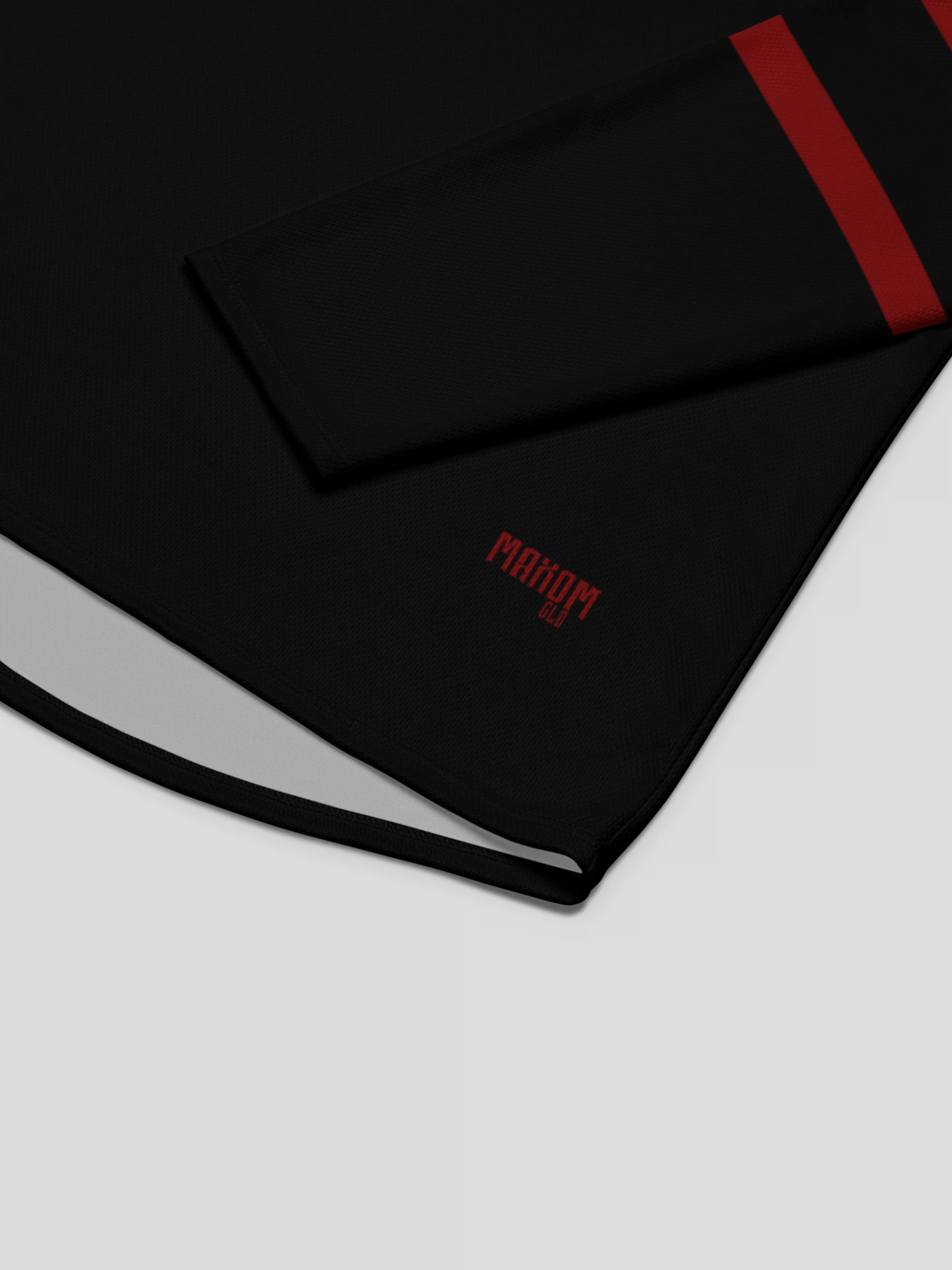 Close-up detail of the MAXOMclo logo embroidery on the eco-conscious recycled hockey sweater, showing premium stitching and sustainable craftsmanship.