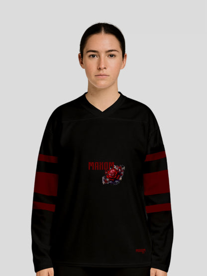 Model wearing the Premium Recycled Hockey Sweater "Roses" by MAXOMclo – unisex black sustainable streetwear sweater featuring a minimalist red rose graphic and vintage-inspired hockey jersey design.