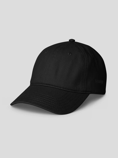 Side view of REMNANT. COLD CAP black – premium cotton twill unisex streetwear cap in deep matte finish.