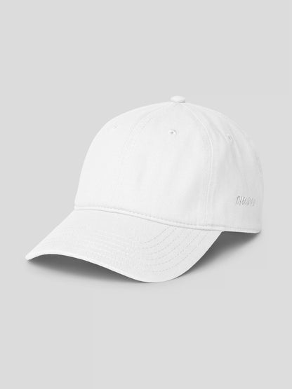 Side view of REMNANT. COLD CAP white – premium cotton twill unisex streetwear cap with clean minimalist design.