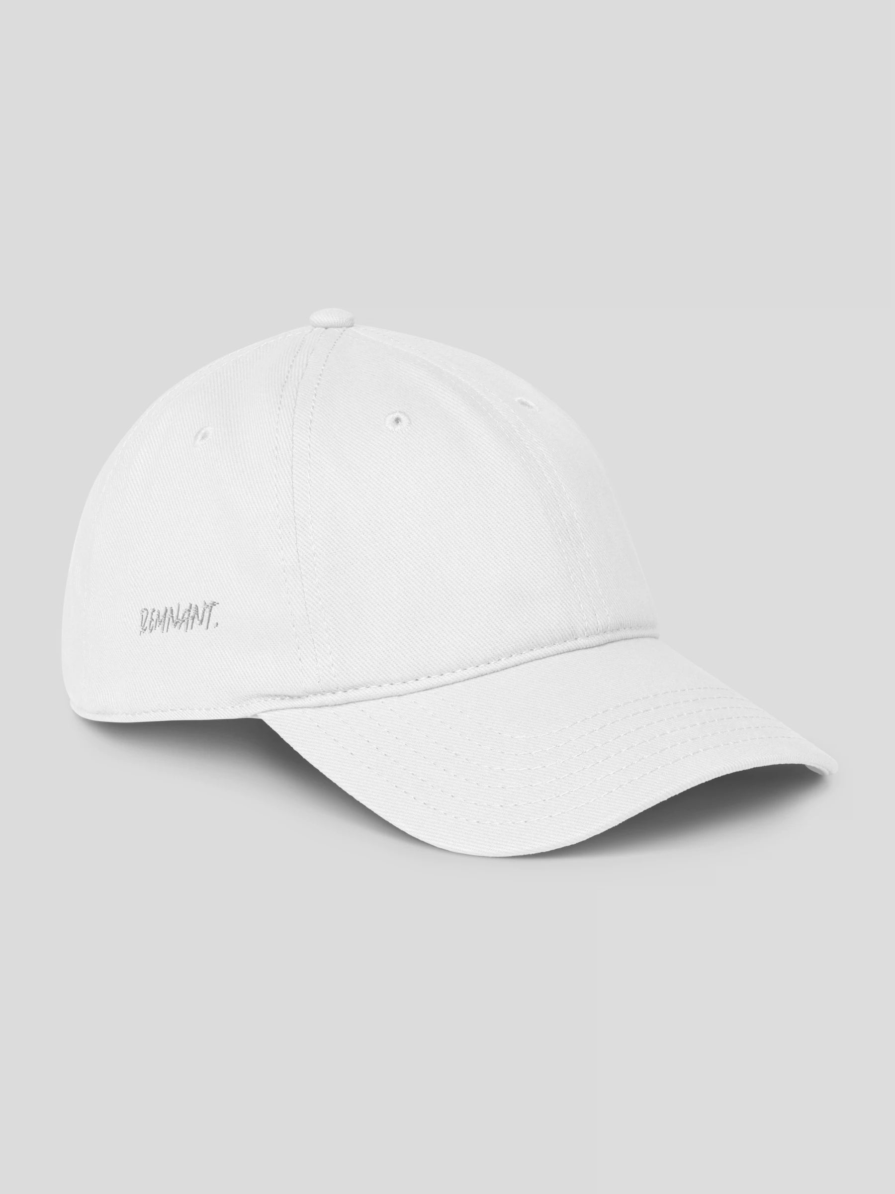 Right side of REMNANT. COLD CAP white – luxury minimalist baseball cap for modern streetwear outfits.