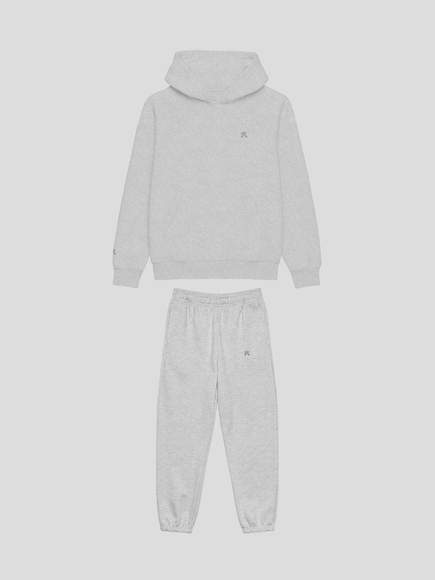 Front view of REMNANT. COLD THEORY.01 grey oversized hoodie and sweatpants set – clean minimalist streetwear design with embroidered logo