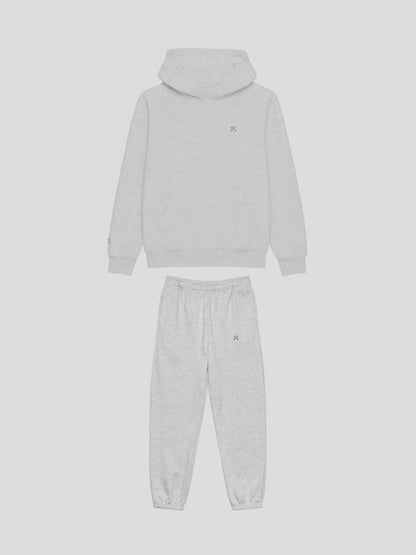 Front view of REMNANT. COLD THEORY.01 grey oversized hoodie and sweatpants set – clean minimalist streetwear design with embroidered logo
