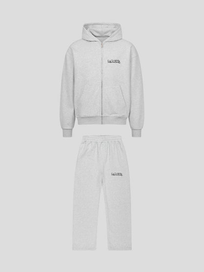 Flat lay front view of REMNANT ECLIPSE_R0 grey oversized hoodie and sweatpants set featuring graffiti logo and minimalist urban design