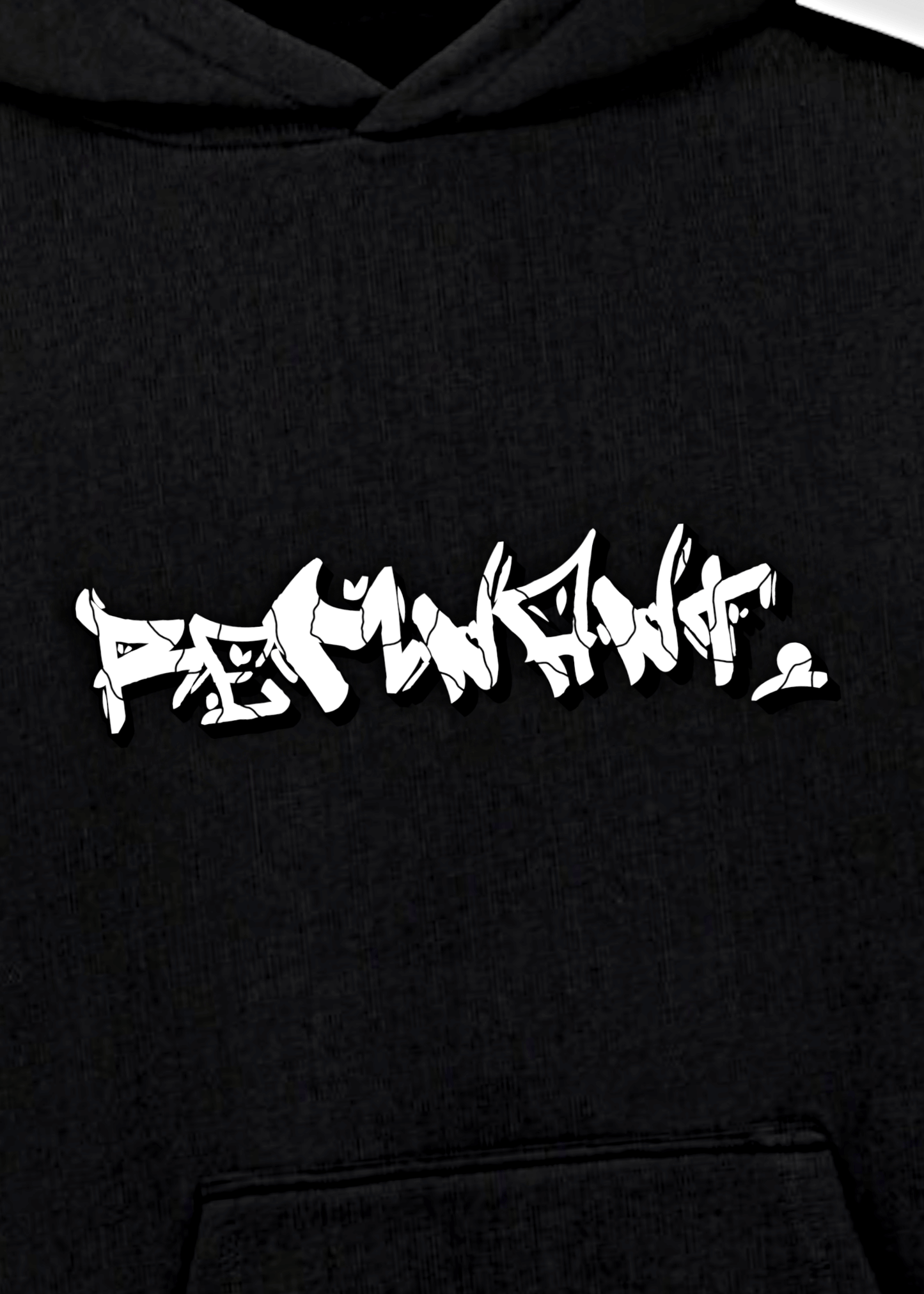 Close-up of graffiti-style REMNANT. logo on oversized black urban streetwear hoodie – mindset-driven statement design.