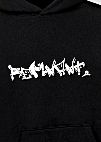 Close-up of graffiti-style REMNANT. logo on oversized black urban streetwear hoodie – mindset-driven statement design.