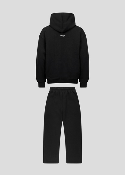 Back flatlay of black oversized graffiti hoodie and sweatpants set
