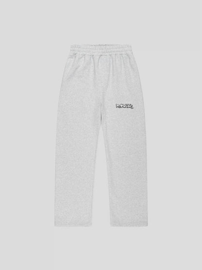 Front view of REMNANT. LIMITED grey sweatpants with REMNANT. logo print on thigh