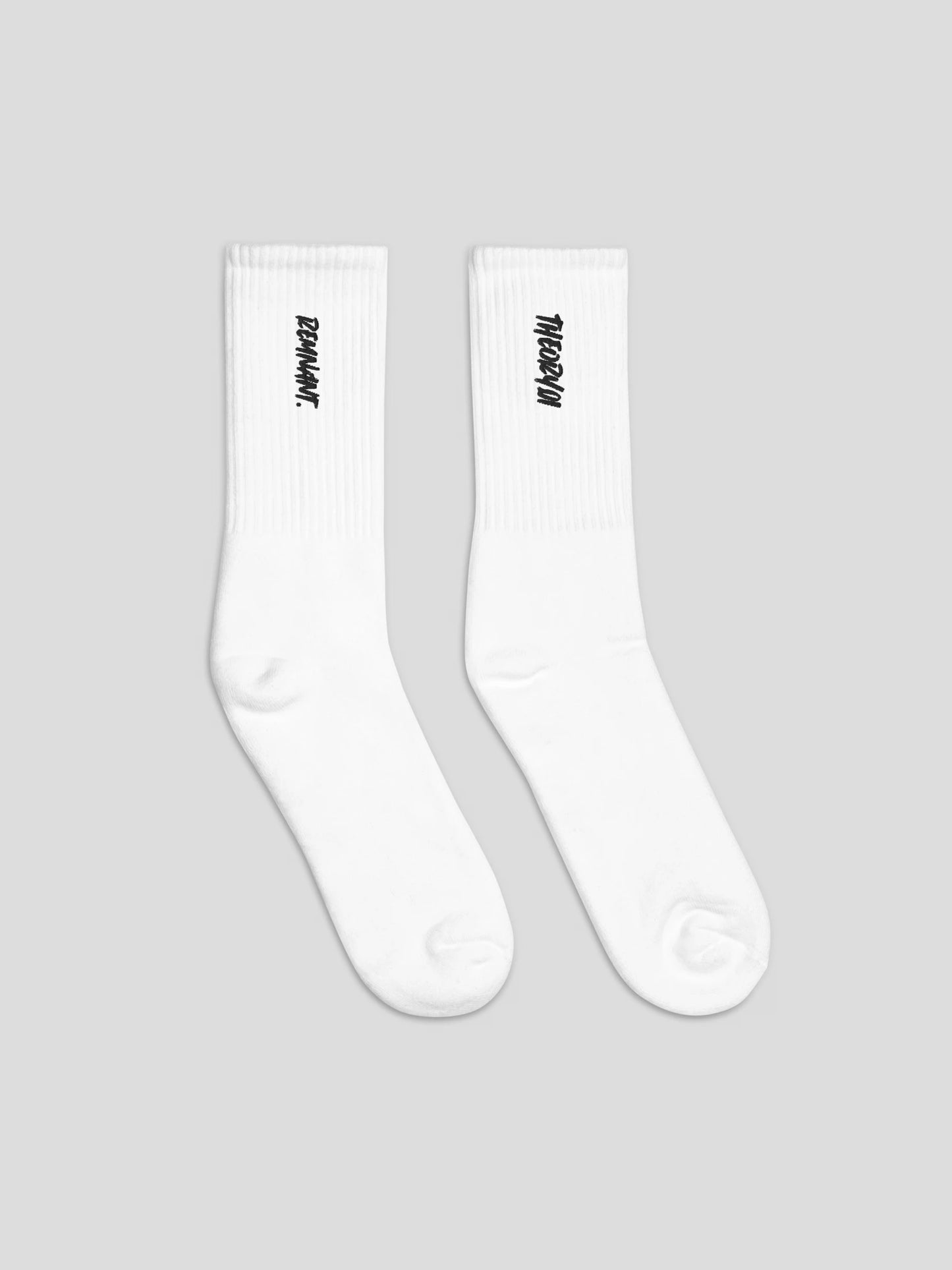 Side angle of REMNANT. THEORY101 black socks with white embroidery – luxury unisex streetwear socks