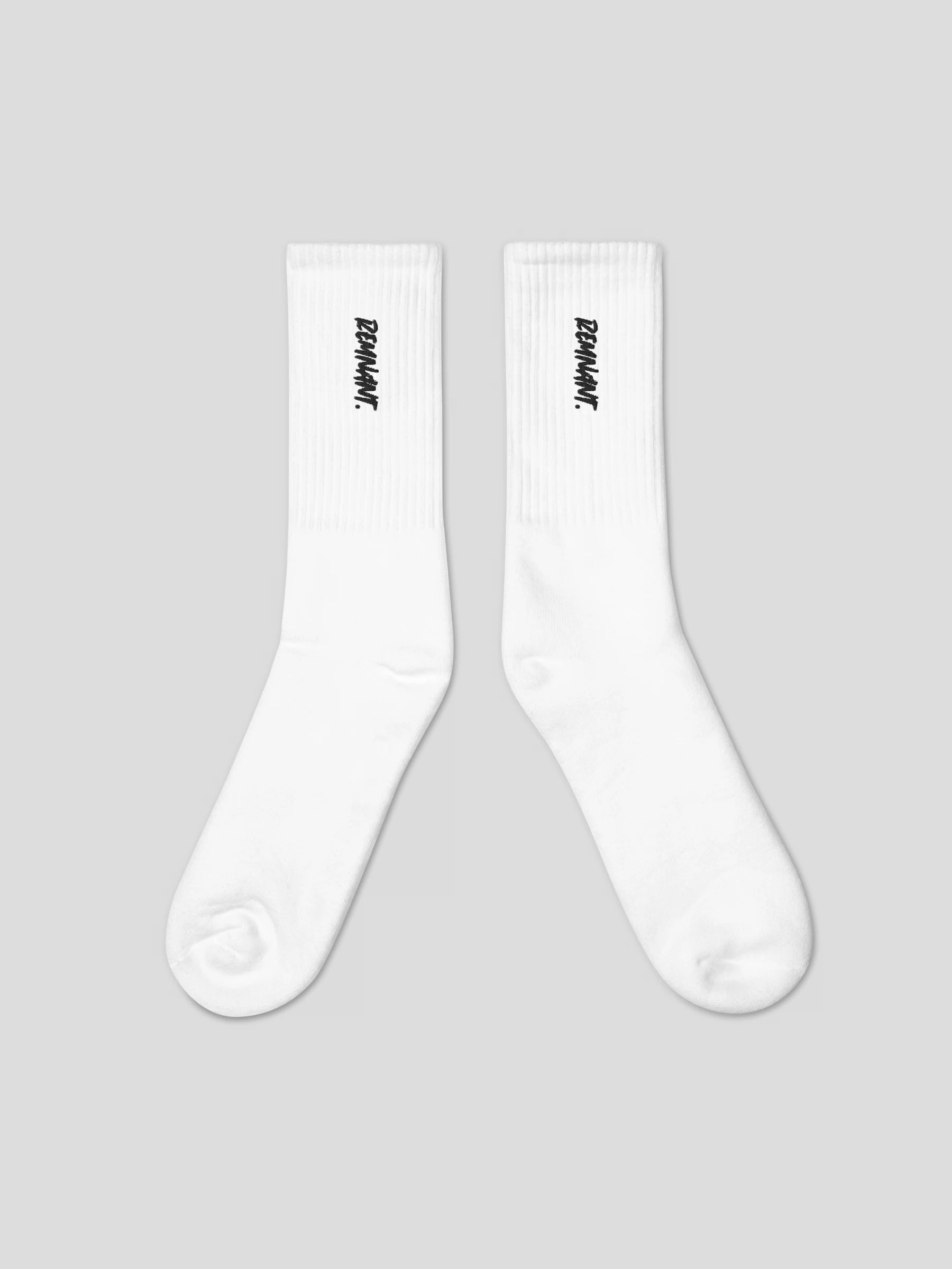 Close-up of REMNANT. embroidered logo on black streetwear socks