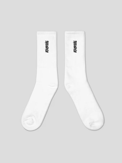 Close-up of THEORY01 logo embroidery on black premium streetwear socks