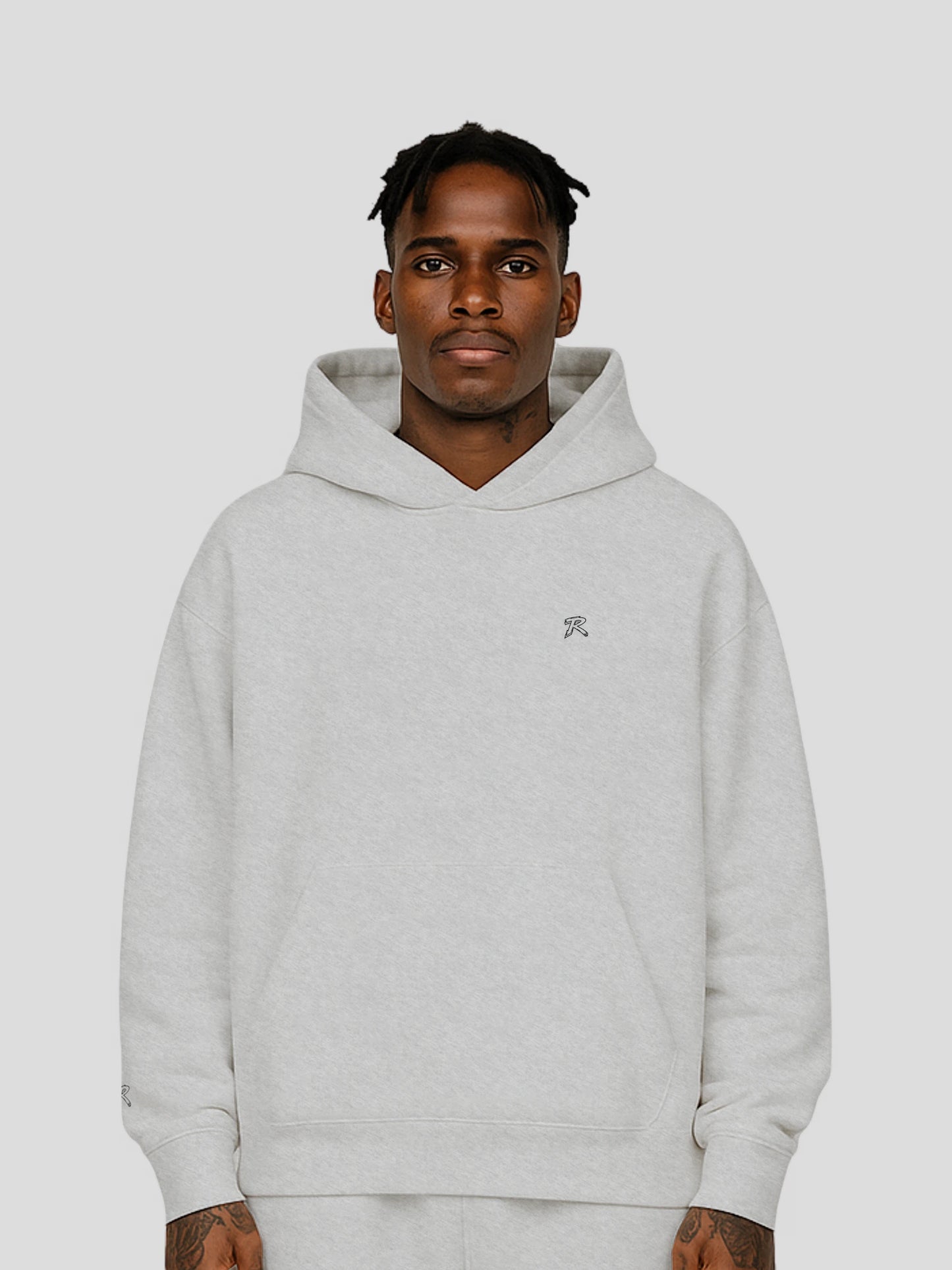 Model wearing REMNANT. THEORY.01 Hoodie in COLD Grey – relaxed oversized streetwear fit with soft brushed fleece and subtle branding