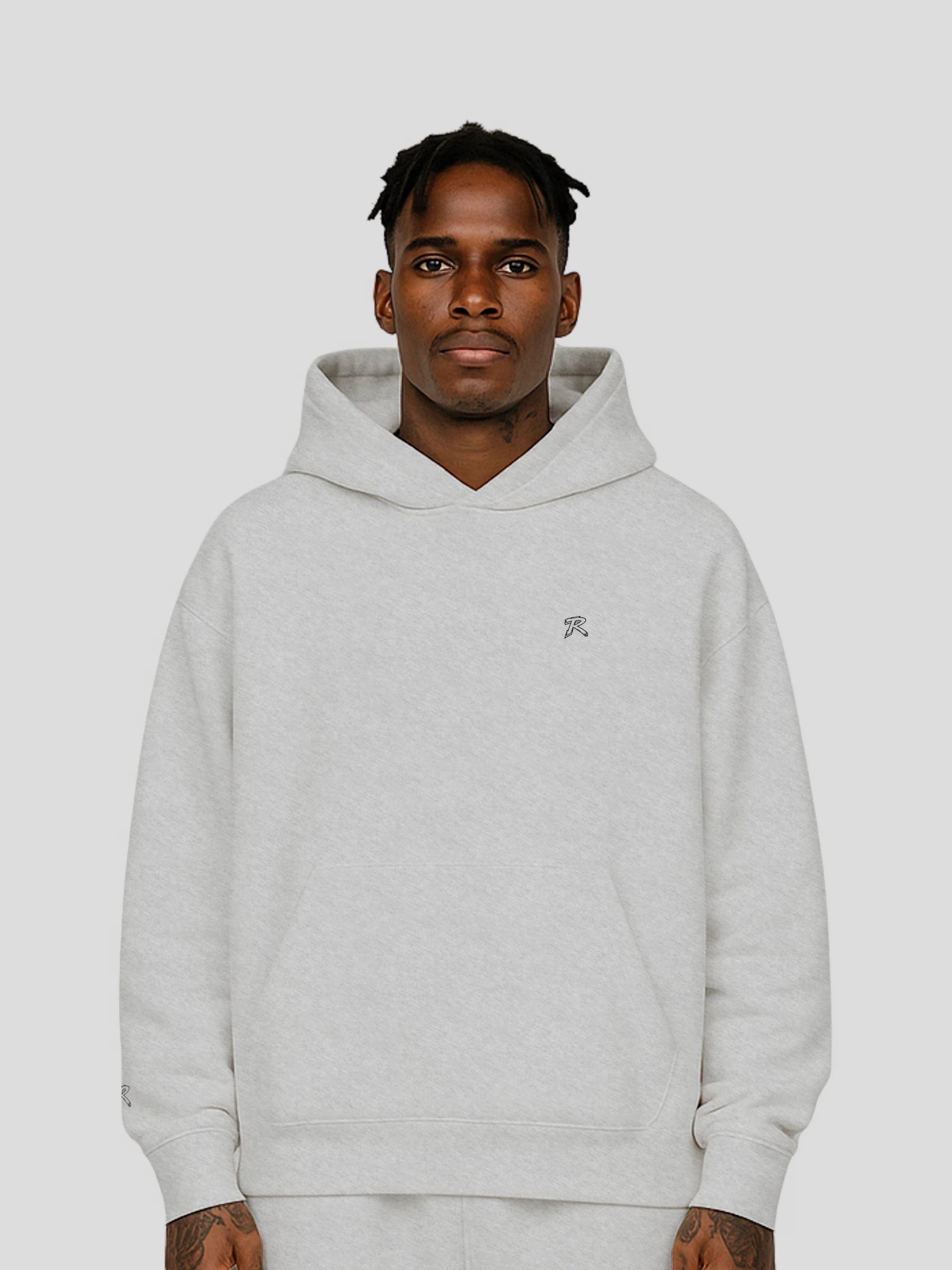 Model wearing REMNANT. THEORY.01 Hoodie in COLD Grey – relaxed oversized streetwear fit with soft brushed fleece and subtle branding