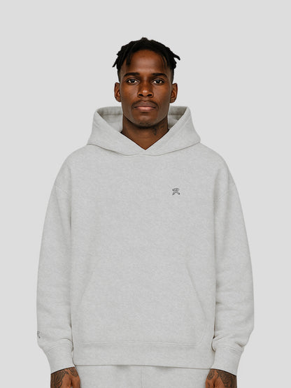 Model wearing REMNANT. THEORY.01 Hoodie in COLD Grey – relaxed oversized streetwear fit with soft brushed fleece and subtle branding