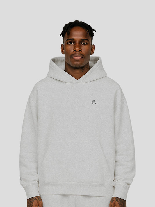 Model wearing REMNANT. THEORY.01 Hoodie in COLD Grey – relaxed oversized streetwear fit with soft brushed fleece and subtle branding