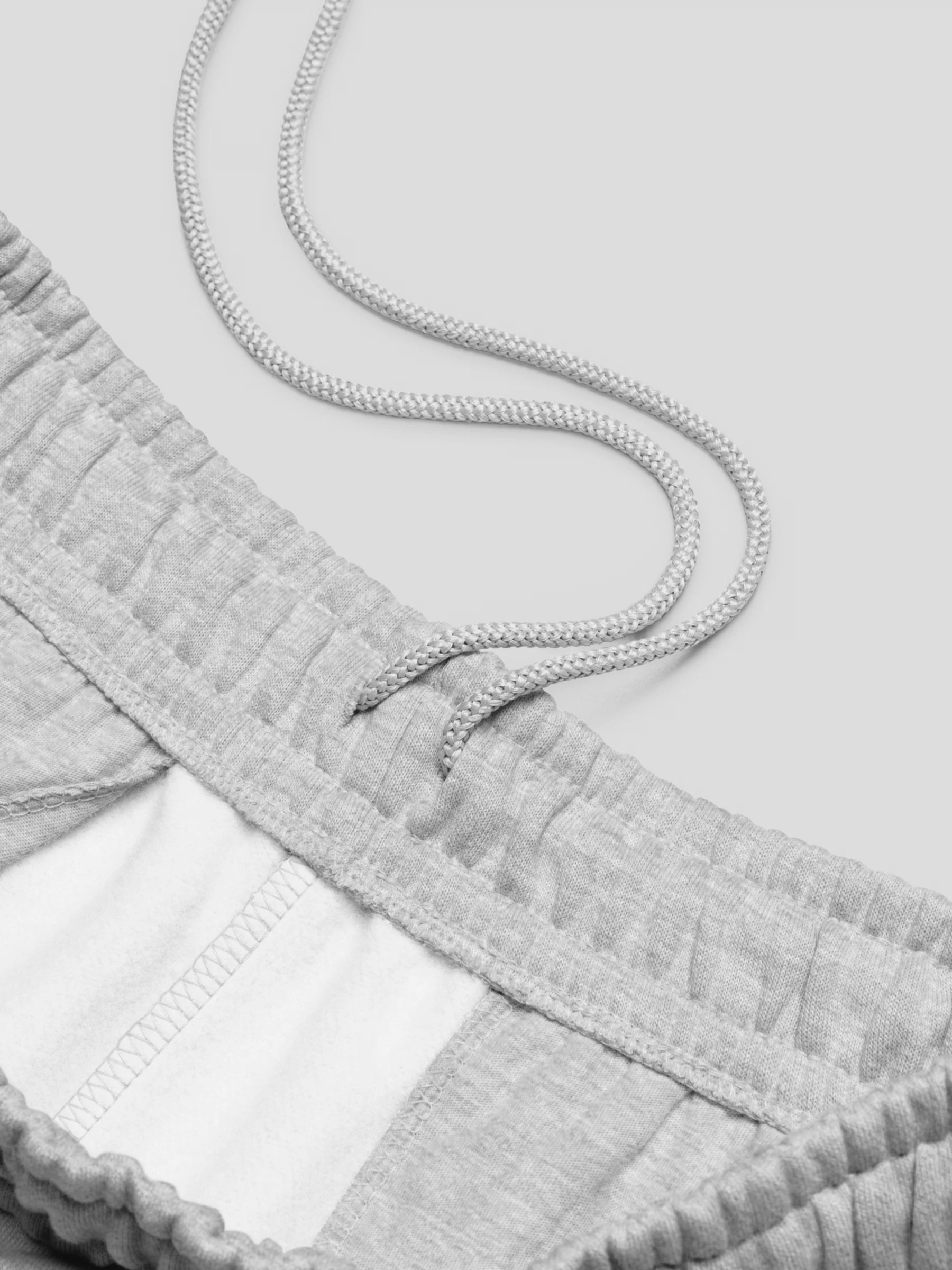 Close-up of REMNANT. THEORY.01 SWEATS COLD Grey waistband – soft brushed fleece interior and adjustable drawcord detail
