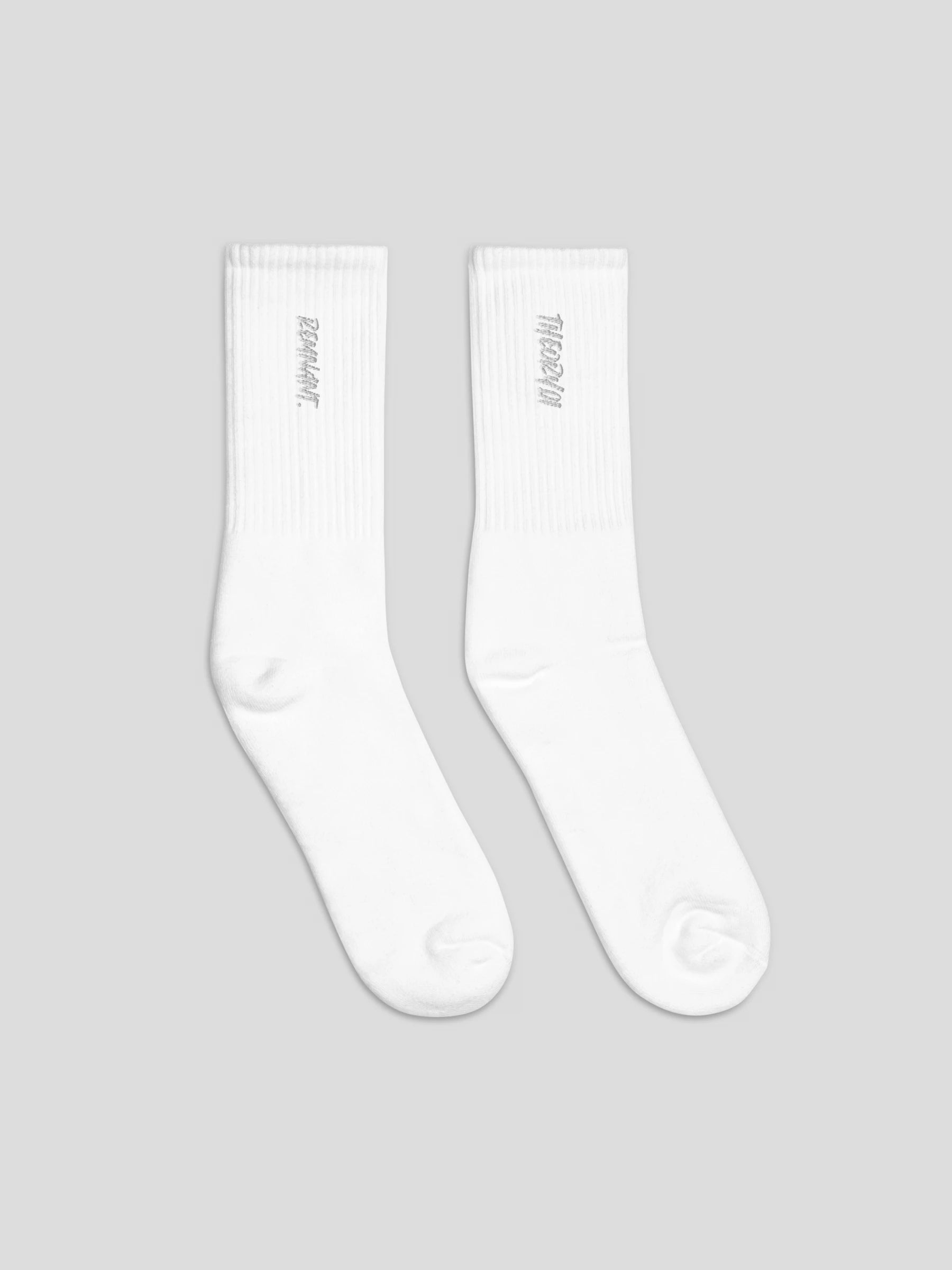 Side angle of REMNANT. THEORY01 white socks with black embroidery – luxury unisex streetwear socks
