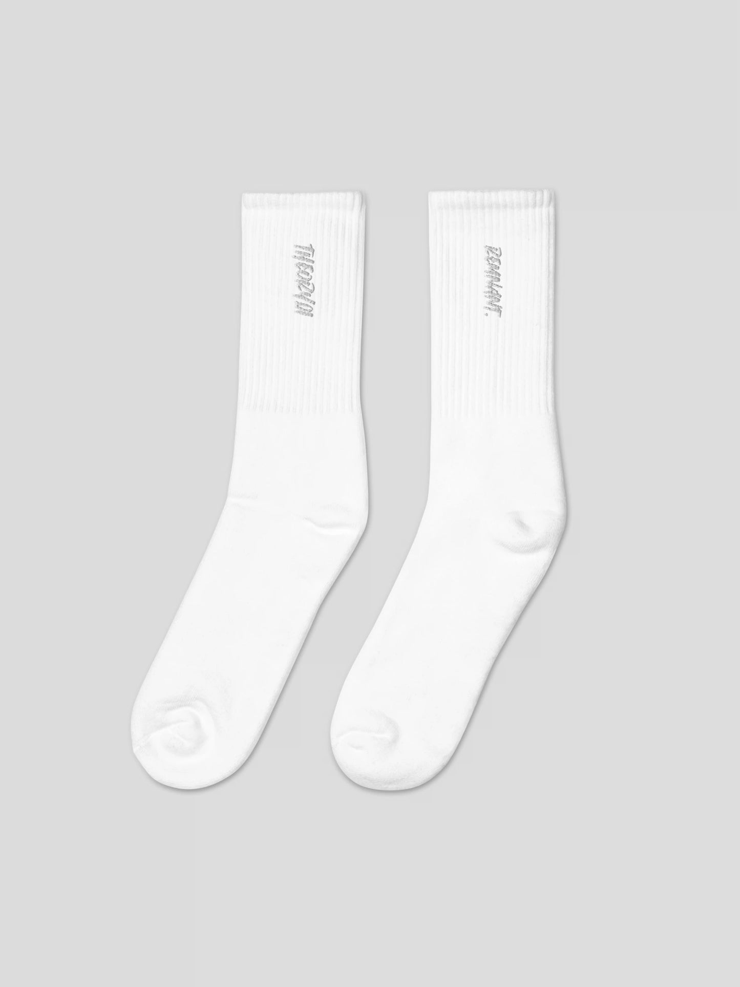 Front view of REMNANT. THEORY01 white socks – minimalist embroidered streetwear design