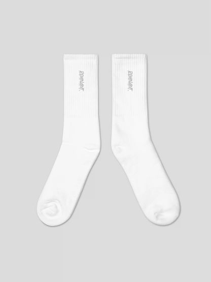 Close-up of REMNANT. embroidered logo on white streetwear socks