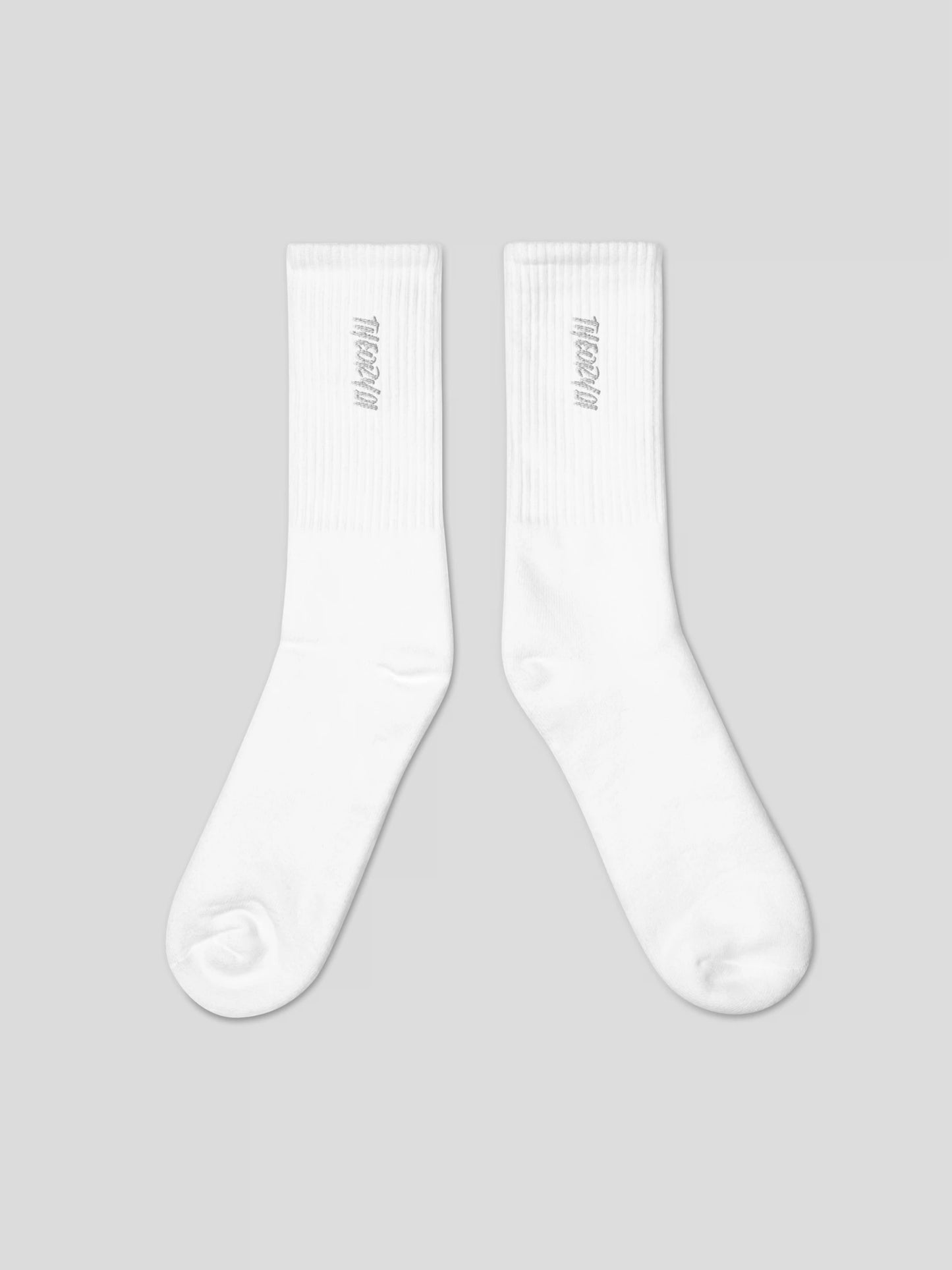 Close-up of THEORY01 logo embroidery on white premium streetwear socks
